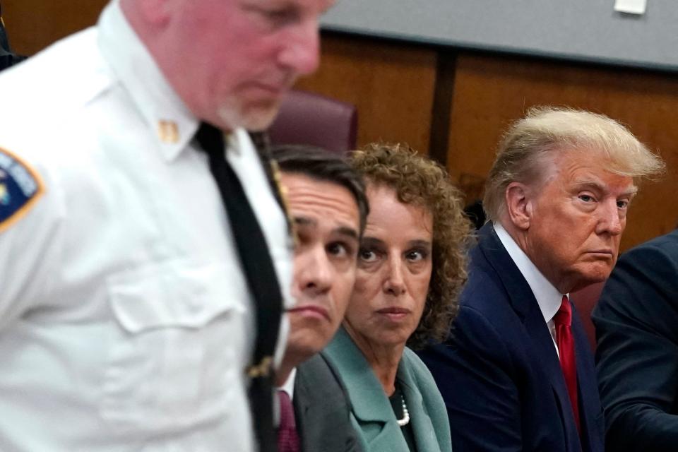 Donald Trump at his hush-money arraignment with attorneys Todd Blanche and Susan Necheles.