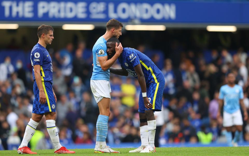 Ruben Dias of Manchester City interacts with Antonio Ruediger of Chelsea. - Catherine Ivill/Getty Images