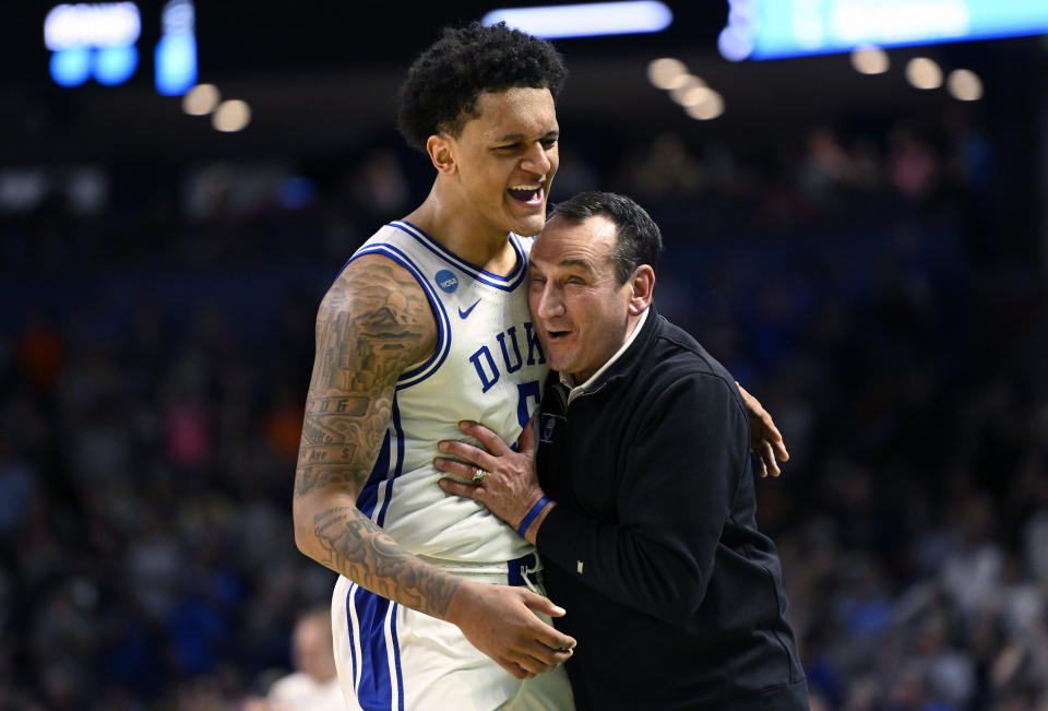 GREENVILLE, SOUTH CAROLINA - MARCH 20: Paolo Banchero #5 and head coach Mike Krzyzewski of the Duke Blue Devils embrace after defeating the Michigan State Spartans 85-76 during the second round of the 2022 NCAA Men's Basketball Tournament at Bon Secours Wellness Arena on March 20, 2022 in Greenville, South Carolina. (Photo by Eakin Howard/Getty Images)