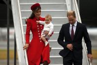 Britain's Prince William, his wife Catherine, Duchess of Cambridge and their son Prince George disembark from their plane after arriving in Wellington April 7, 2014. The Prince and his wife Kate are undertaking a 19-day official visit to New Zealand and Australia with their son George. REUTERS/Phil Noble (NEW ZEALAND - Tags: ENTERTAINMENT ROYALS TPX IMAGES OF THE DAY)