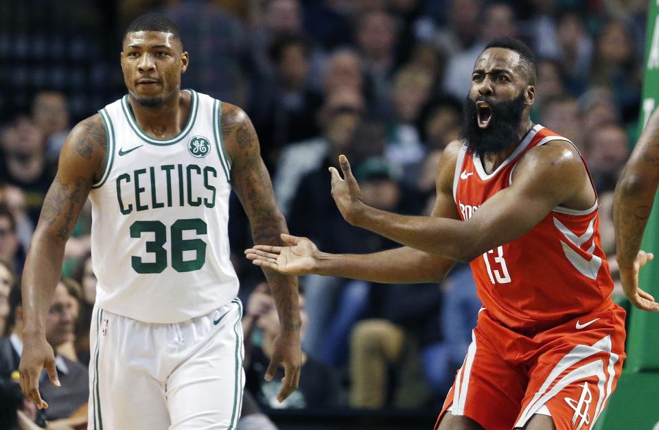 Rockets guard James Harden protests a call next to Celtics guard Marcus Smart on Saturday night. (AP)