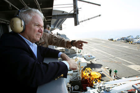 FILE PHOTO: U.S. Secretary of Defense Robert Gates watches flight operations from "Vulture's Row" aboard the USS Abraham Lincoln in the Arabian Sea. Gates toured the aircraft carrier and met with sailors which is on station in the Arabian Sea December 6, 2010. REUTERS/Win McNamee/Pool/File Photo