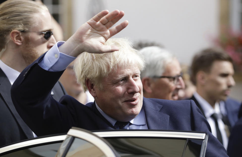 British Prime Minister Boris Johnson, center, waves as he departs after a meeting with European Commission President Jean-Claude Juncker in Luxembourg, Monday, Sept. 16, 2019. British Prime Minister Boris Johnson held his first meeting with European Commission President Jean-Claude Juncker on Monday in search of a longshot Brexit deal. (AP Photo/Olivier Matthys)