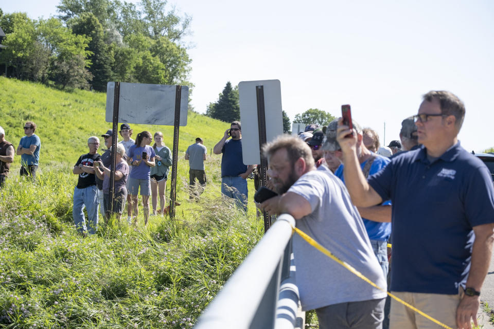 Spectators catch a glimpse of the damage to the Rapidan Dam in Rapidan, Minn., Monday, June 24, 2024. (Casey Ek/The Free Press via AP)