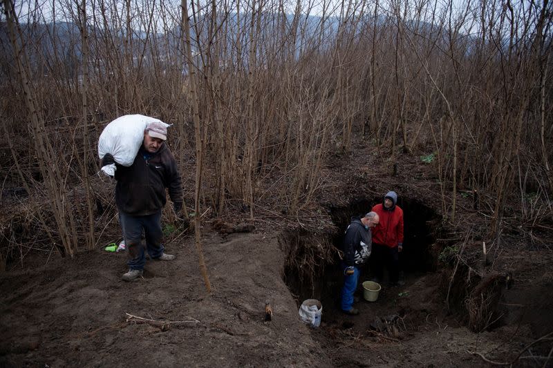 The Wider Image: Hungary's poor burn plastic bottles to stay warm, creating deadly smog