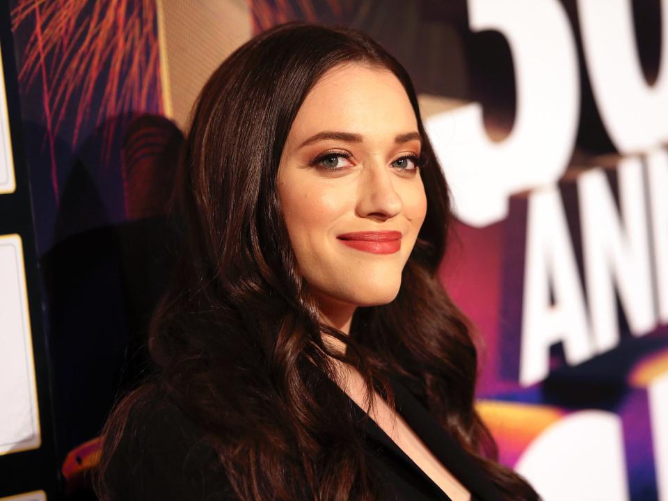 Kat Dennings smiles at an event