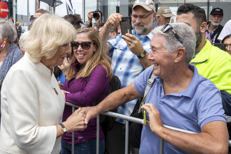 Camilla, Duchess of Cornwall, left, greets members of the public during a walk at Viaduct Harbour in Auckland during their royal visit to New Zealand, Tuesday, Nov. 19, 2019. The visit is part of a week-long tour of the country which also takes in Christchurch and Kaikoura. (David Rowland/Pool Photo via AP)