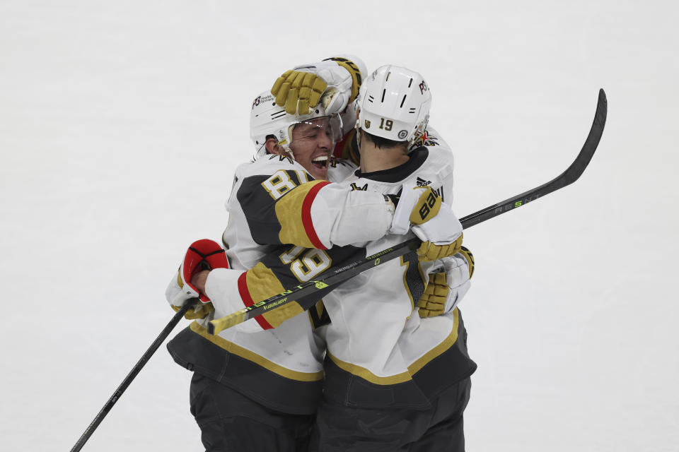 Vegas Golden Knights right wings Reilly Smith (19) and Jonathan Marchessault (81) celebrate after Smith scored the winning goal in a shootout of an NHL hockey game against the Minnesota Wild, Monday, April 3, 2023, in St. Paul, Minn. (AP Photo/Stacy Bengs)