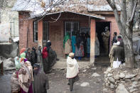 Kashmiris stand in a queue to cast their votes during the first phase of District Development Councils election on the outskirts of Srinagar, Indian controlled Kashmir, Saturday, Nov. 28, 2020. Thousands of people in Indian-controlled Kashmir voted Saturday amid tight security and freezing cold temperatures in the first phase of local elections, the first since New Delhi revoked the disputed region's semiautonomous status. (AP Photo/Mukhtar Khan)