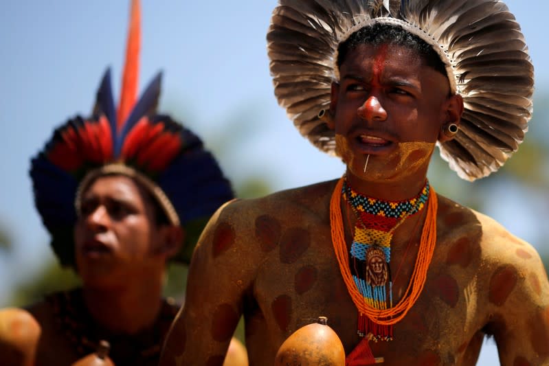 FILE PHOTO: Indigenous people from ethnic groups Pataxo and Tupinamba attend a protest to defend indigenous land, outside Brazil's Supreme Federal Court in Brasilia