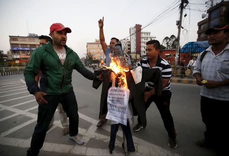 Nepalese youths burn an effigy of India's Prime Minister Narendra Modi during a protest against the logjam at the Nepal-India border in Kathmandu, Nepal September 30, 2015. REUTERS/Navesh Chitrakar