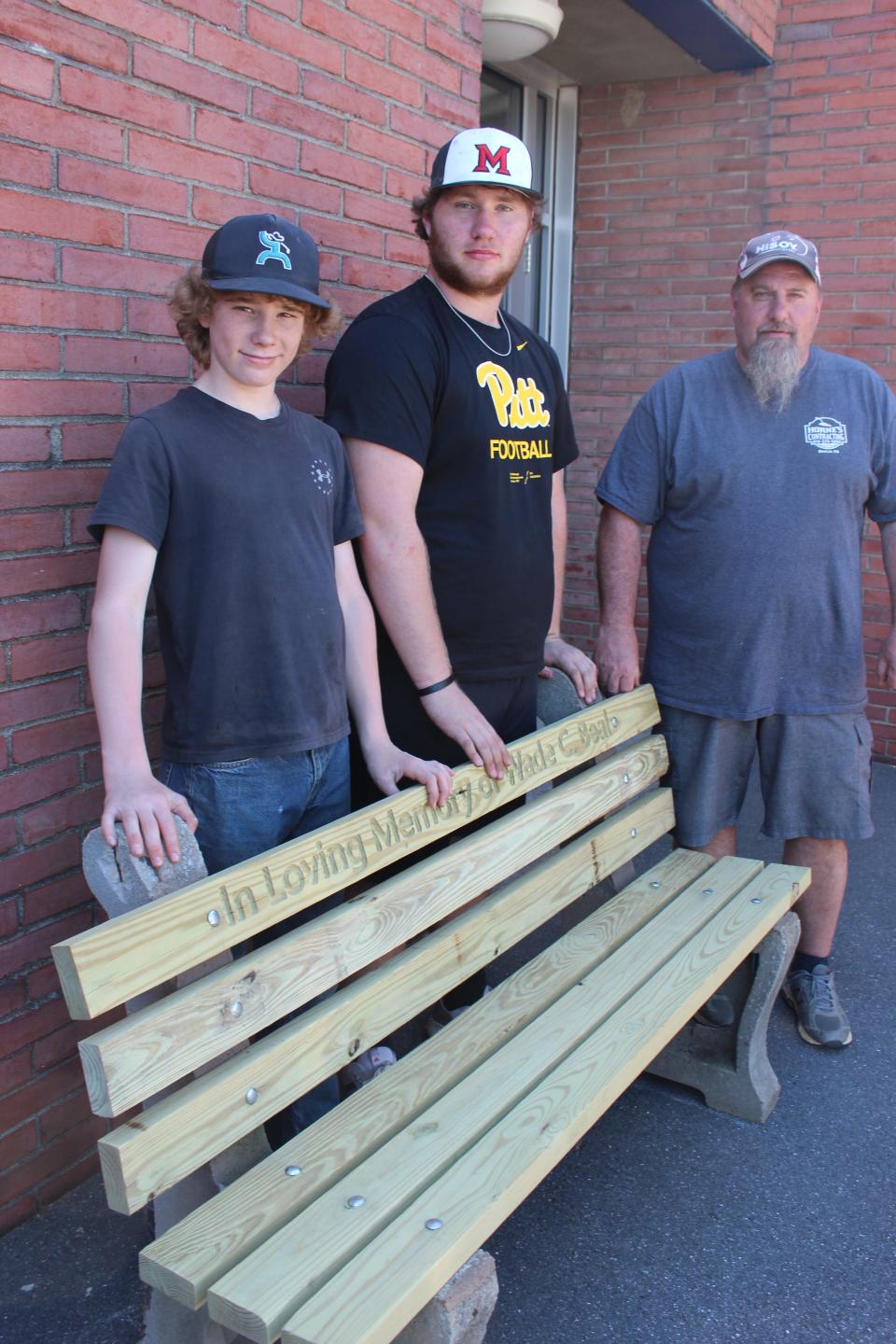 Caden Snyder and Landon Ludy, both students in Doug Horne's technology education classes at Meyersdale Area High School, restored a discarded wooden bench (pictured here) using new technology. Horne is pictured to the right. The bench is in memory of the late Wade Beal of Meyersdale.