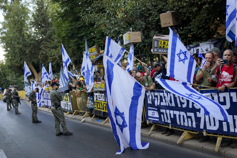 Israelis protest against plans by Prime Minister Benjamin Netanyahu's government to overhaul the judicial system and in support of the Supreme Court ahead of Thursday's pivotal hearing, in Jerusalem, Thursday, Sept. 28, 2023. The hearing over a law that makes it more difficult to remove Netanyahu from office deepens a rift between the government and the judiciary amid months of turmoil in Israel. (AP Photo/Ohad Zwigenberg)