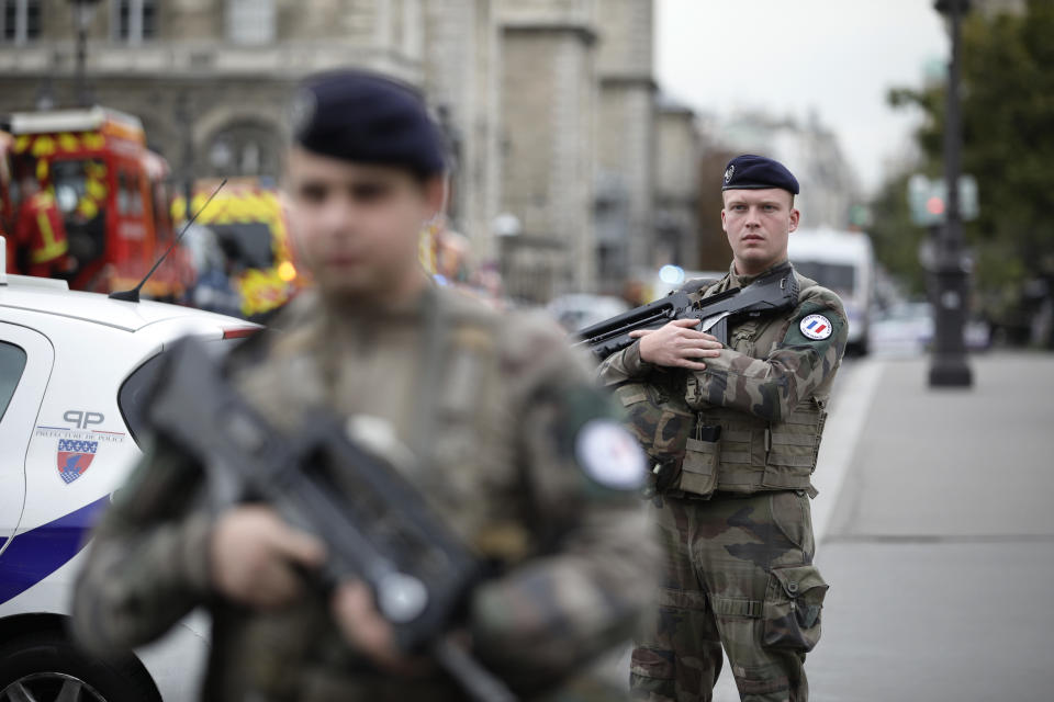 Armed soldiers patrol after an incident at the police headquarters in Paris, Thursday, Oct. 3, 2019. A French police union official says an attacker armed with a knife has killed one officer inside Paris police headquarters before he was shot and killed. (AP Photo/Kamil Zihnioglu)