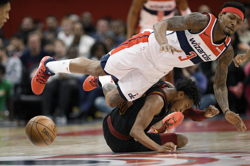 Cleveland Cavaliers guard Darius Garland, bottom, and Washington Wizards guard Bradley Beal are unable to come up with the ball during the second half of an NBA basketball game Friday, Feb. 21, 2020, in Washington. Garland was called for a foul on the play. The Cavaliers won 113-108. (AP Photo/Nick Wass)