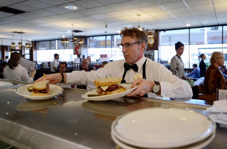 Waiter Dan Smith serves Langer's Delicatessen famous #19 pastrami sandwiches on February 26, 2013 in Los Angeles, California. (Getty)