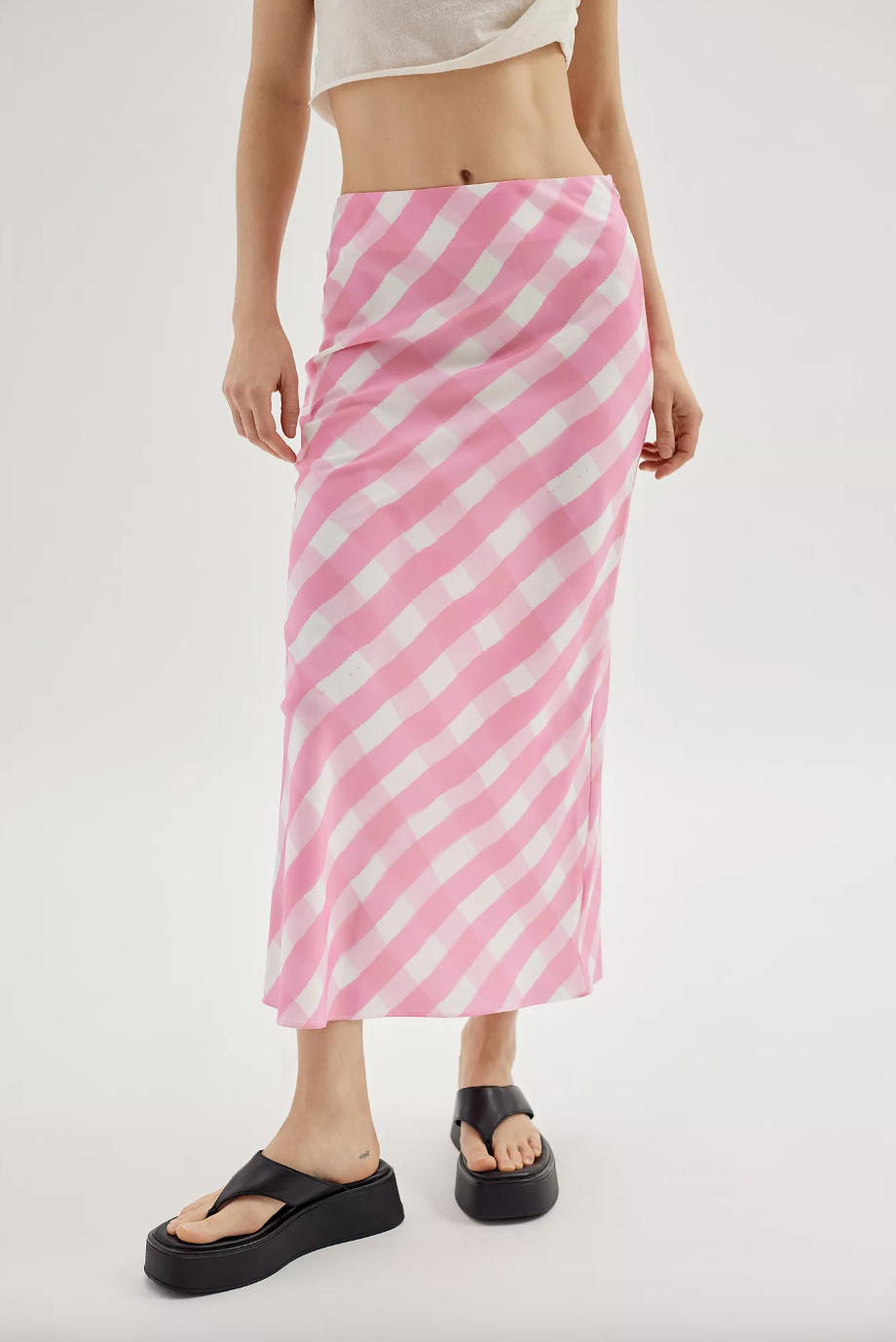 model wearing pink and white Glamorous Ladies Gingham Midi Skirt (Photo via Urban Outfitters)