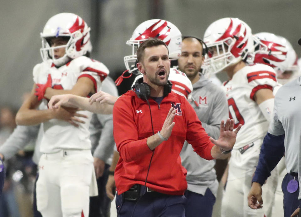 In this Dec. 12, 2018 photo, Milton coach Adam Clack reacts on the sideline during the first half against Colquitt County during the Class 7A high school football championship at Mercedes-Benz Stadium in Atlanta. Georgia has become the clear No. 4 state behind Texas, Florida and California for producing major college football players. (Jason Getz/Atlanta Journal-Constitution via AP)