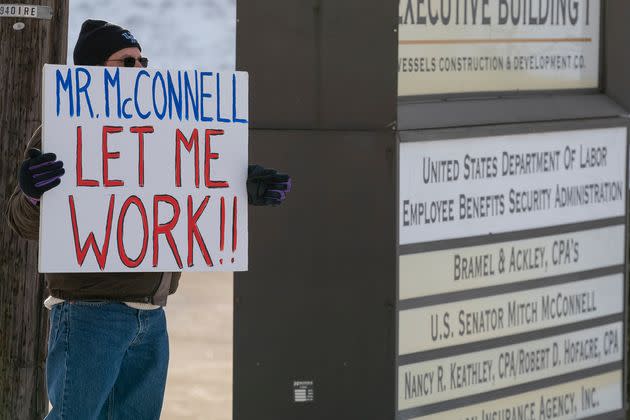 Furloughed Environmental Protection Agency worker Jeff Herrema holds a sign outside the offices of Sen. Mitch McConnell in Park Hills, Kentucky, during a government shutdown in January 2019.