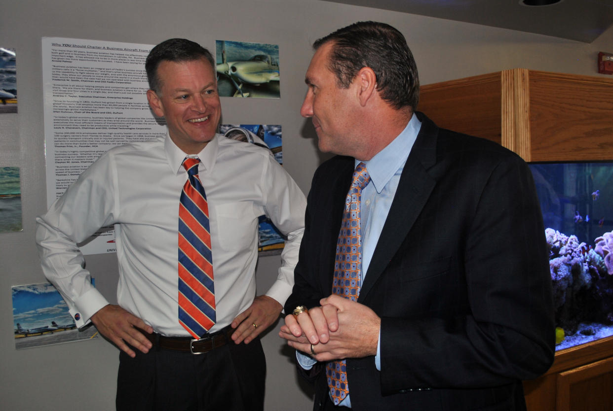 Scott Stricklin chops it up with Dan Mullen after hiring him to be Florida’s head football coach. (AP Photo/Mark Long)