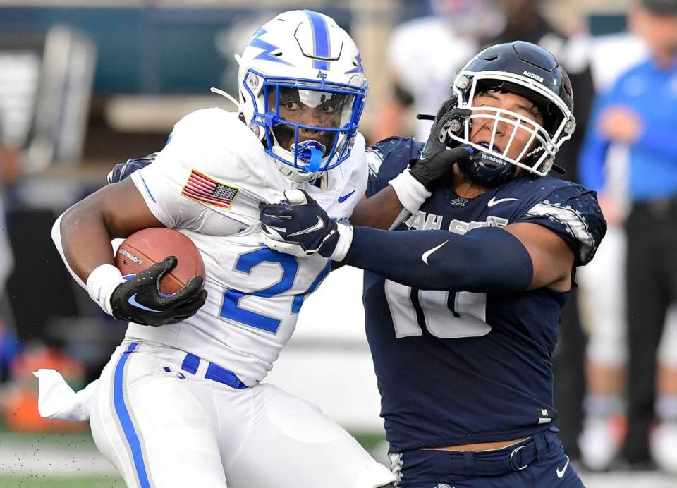 Air Force running back John Lee Eldridge III (24) spins away from Utah State linebacker AJ Vongphachanh (10) during the first half of an NCAA college football game Saturday, Oct. 8, 2022, in Logan, Utah.