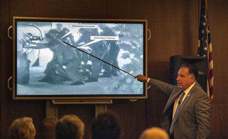 Orange County District Attorney Tony Rackauckas shows the jury an image of Fullerton police trying to subdue Kelly Thomas at the Fullerton Transportation Center taken on July 5, 2011 during his opening statements in the People v. Ramos and Cicinelli trial at Orange County Superior Court in Santa Ana, California, December 2, 2013. REUTERS/Bruce Chambers/Pool LAW)