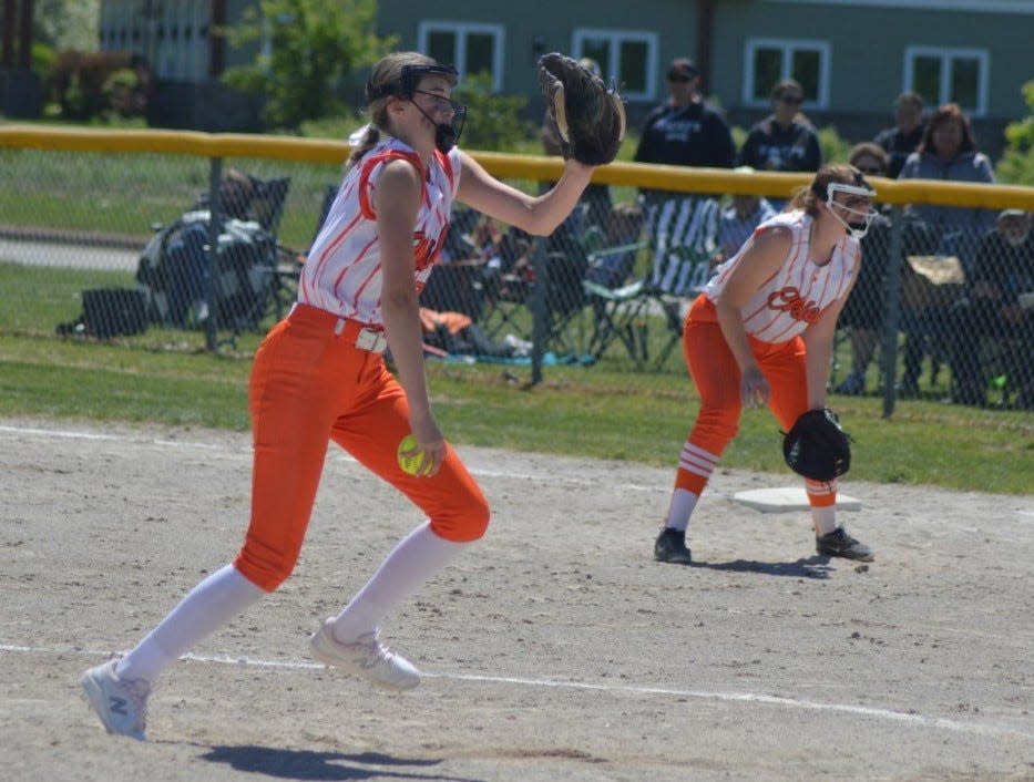 Cheboygan's Amelia Johnson winds up a pitch as teammate Kaitlyn Penfield watches from first base during an MHSAA Division 2 District 33 semifinal against the Escanaba Eskymos Saturday in Sault Ste. Marie.