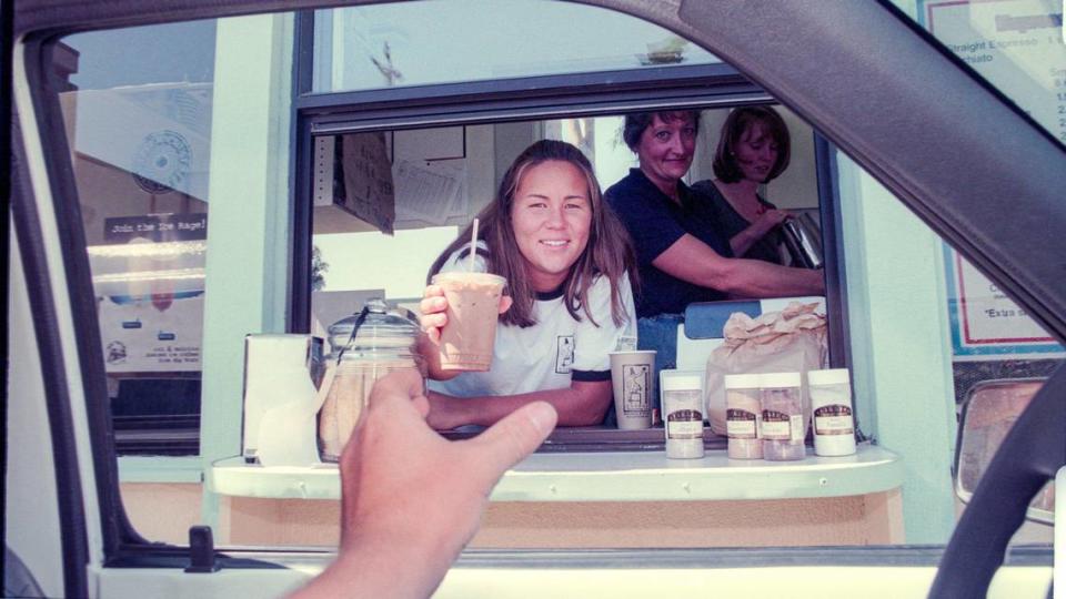 Handoff: Sasha Boehling serves up an iced mocha at the Java Connection drive-through espresso bar in Madonna Plaza, Aug. 13, 1998. The business, which opened earlier this month, found a loophole in San Luis Obispo’s ban on drive-throughs. Joe Johnston/Telegram-Tribune