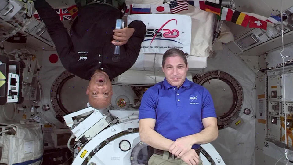 Victor Glover (left) and Mike Hopkins on board the International Space Station. Technically, neither one of them is upside-down.  / Credit: CBS News