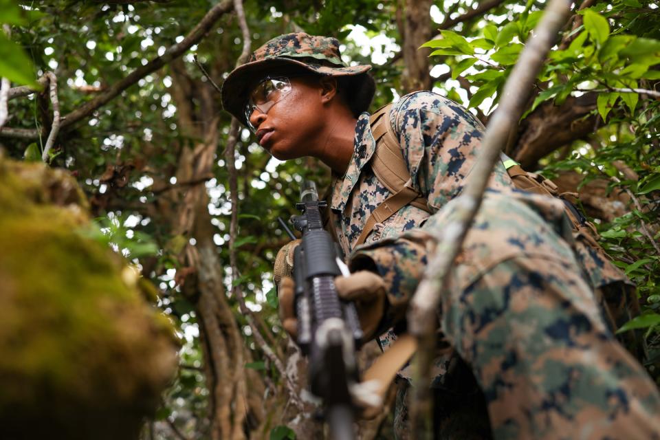 Marine Corps Sgt. Andrea Rosembert posts security during a halt on a training patrol at Andersen Air Force Base, Guam, March 15, 2024.