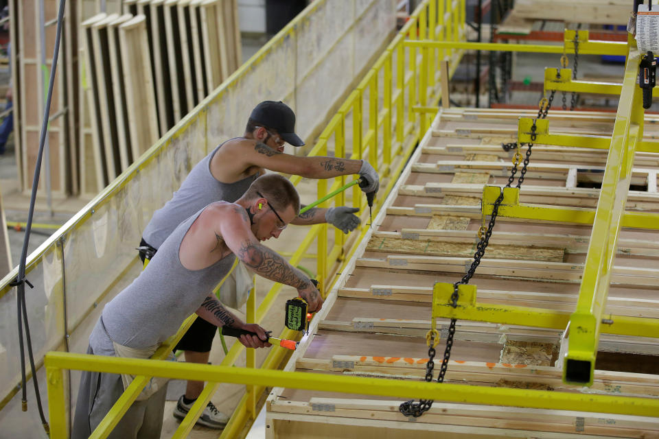 Workers build the roof of a single axel towable Pioneer traditional recreational vehicle at the Thor Industries Heartland RV Assembly Plant in Elkhart, Indiana, U.S. June 13, 2017. Picture taken June 13, 2017. REUTERS/Joshua Lott To match Special Report USA-WORKERS/ELKHART