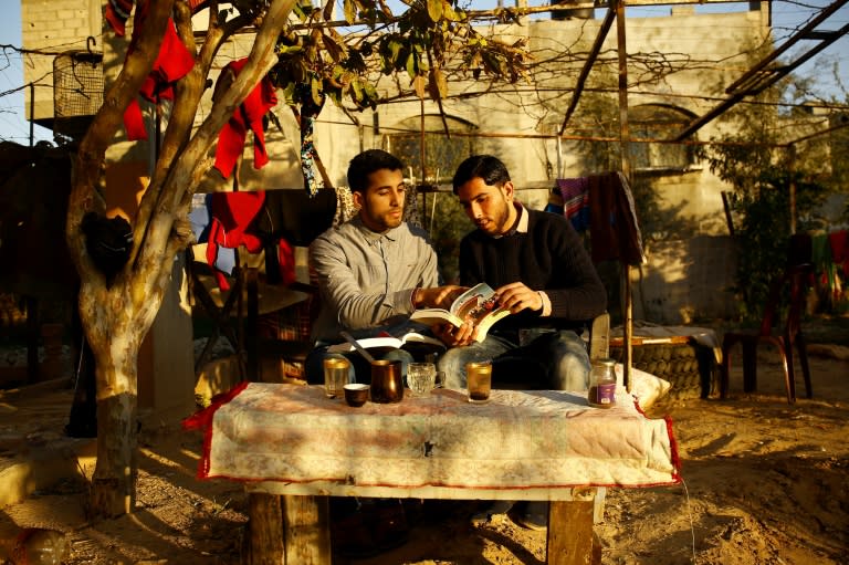 Since launching their "Library & Bookshop for Gaza" Facebook page in July, Mossab Abo Toha (L) and Shafi Salem have collected over 200 books including from US and European donors