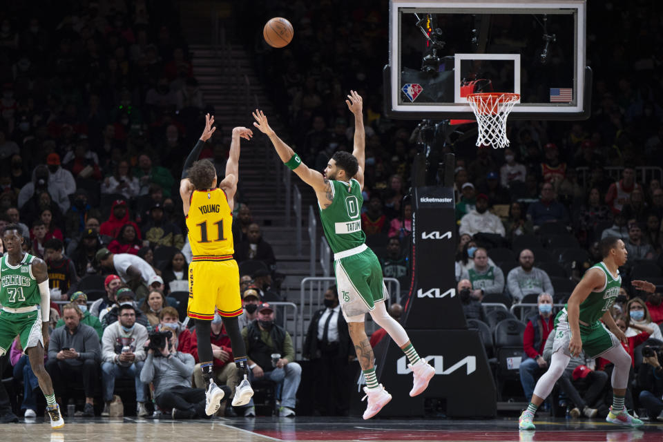 Atlanta Hawks guard Trae Young (11)shoots over Boston Celtics forward Jayson Tatum (0) during the first half of an NBA basketball game Friday, Jan. 28, 2022, in Atlanta. (AP Photo/Hakim Wright Sr.)