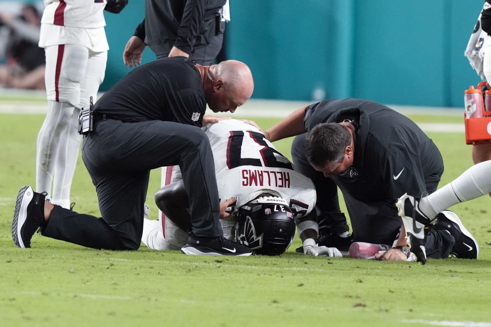 Atlanta Falcons safety DeMarcco Hellams (37) is tended to by memeberas of the Falcons training staff after being injured in the second half of a preseason NFL football game against the Miami Dolphins, Friday, Aug. 11, 2023, in Miami Gardens, Fla. (AP Photo/Marta Lavandier)