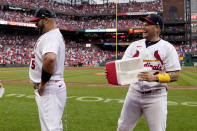 St. Louis Cardinals' Yadier Molina, right, laughs after dousing teammate Albert Pujols (5) with a cooler of water following a baseball game against the Chicago Cubs Sunday, Sept. 4, 2022, in St. Louis. Pujols hit a two-run home run in the eighth inning to lead the Cardinals to a 2-0 victory. (AP Photo/Jeff Roberson)