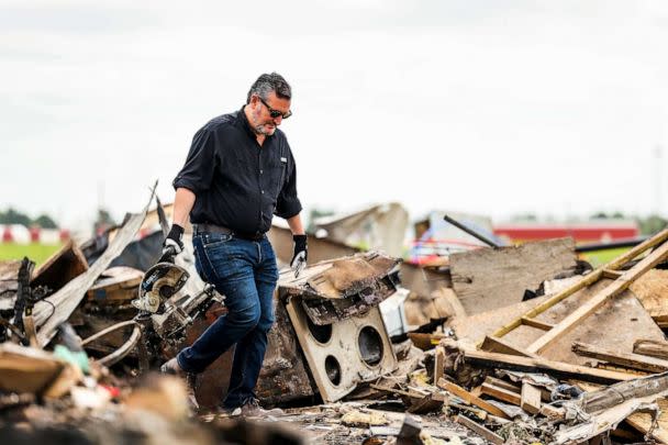 PHOTO: Sen. Ted Cruz carries an item from debris in a trailer park that was damaged by a tornado in Perryton, Texas, June 17, 2023. (David Erickson/AP)