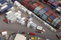 FILE PHOTO: Trucks and workers load containers onto trucks at a container terminal in Sydney, Australia