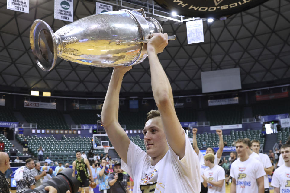 Purdue guard Fletcher Loyer holds the Maui Invitational trophy after Purdue defeated Marquette in an NCAA college basketball game Wednesday, Nov. 22, 2023, in Honolulu. (AP Photo/Marco Garcia)