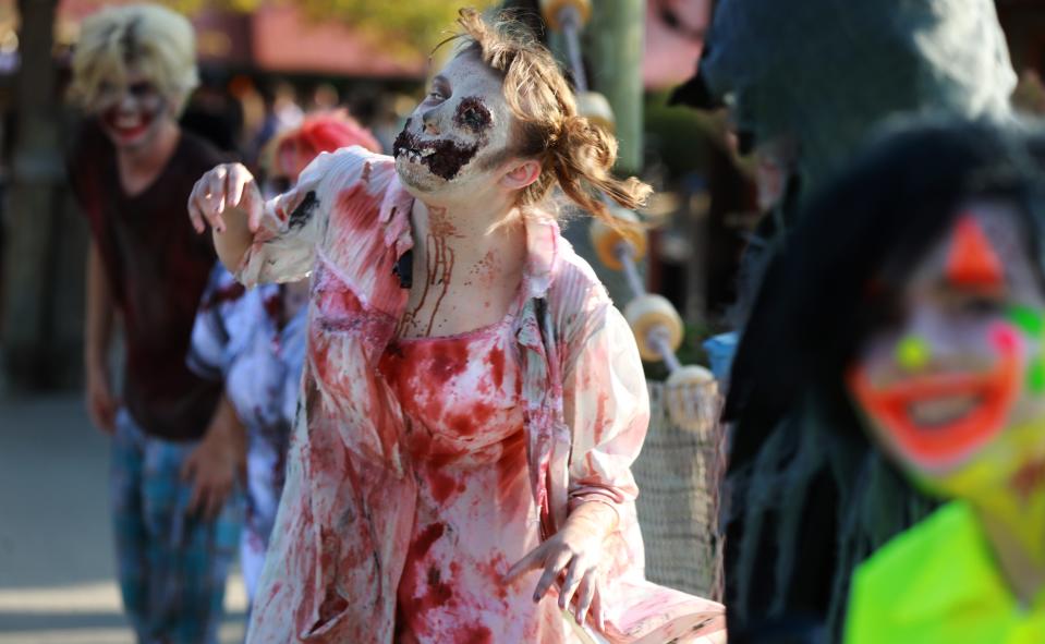 Sara Sullivan plays the role of a zombie at the Columbus Zoo's ZOMBIEzi Bay halloween attraction.