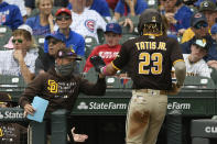 San Diego Padres' Fernando Tatis Jr. (23) celebrates with manager Jayce Tingler, left, at the dugout after scoring on a Wil Myers single during the second inning of a baseball game against the Chicago Cubs on Monday, May 31, 2021, in Chicago. (AP Photo/Paul Beaty)
