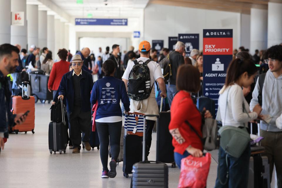 Crowds pass through a terminal at Los Angeles International Airport on November 21, 2023, in Los Angeles, as people travel ahead of the Thanksgiving holiday.