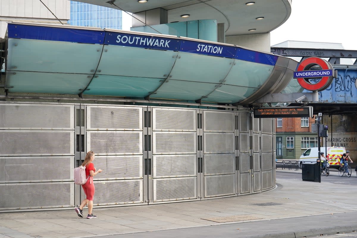 A woman walks past Southwark Station, closed due to strike action (Dominic Lipinski/PA) (PA Wire)