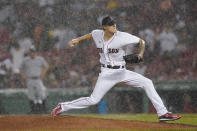 Boston Red Sox starting pitcher Tanner Houck delivers to the New York Yankees during a rain shower in the fifth inning of a baseball game at Fenway Park, Thursday, July 22, 2021, in Boston. (AP Photo/Elise Amendola)