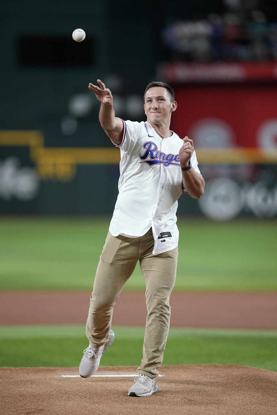 Texas Rangers first-round draft pick Wyatt Langford throws out the ceremonial first pitch before the Rangers' baseball game against the Tampa Bay Rays, Tuesday, July 18, 2023, in Arlington, Texas. (AP Photo/Tony Gutierrez)