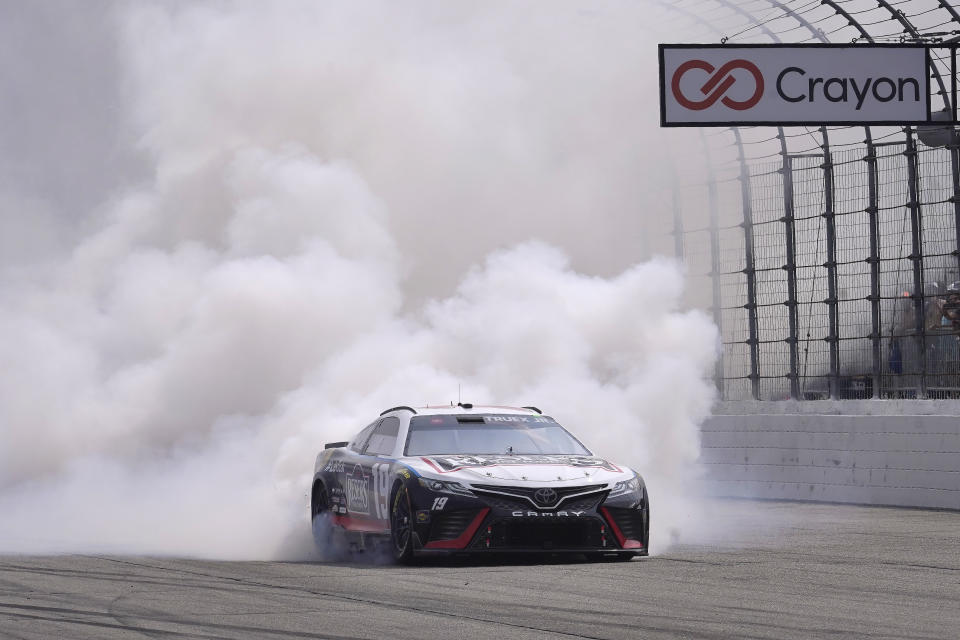 Martin Truex Jr., does a burnout after winning the Crayon 301 NASCAR Cup Series race, Monday, July 17, 2023, at New Hampshire Motor Speedway, in Loudon, N.H. (AP Photo/Steven Senne)