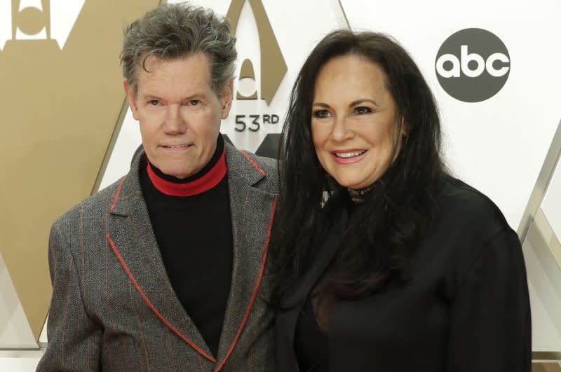 Randy Travis and Mary Davis arrive for the Country Music Association Awards at Bridgestone Arena in Nashville in 2019. File Photo by John Angelillo/UPI