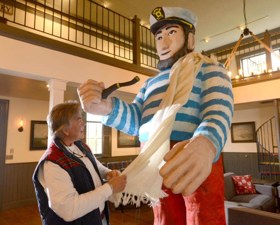Lou Carrier, of Dennis, unwraps the Jolly Captain figure in Worden Hall in East Dennis getting him ready to return to his original location looking out over the Bass River along Route 28 in South Yarmouth