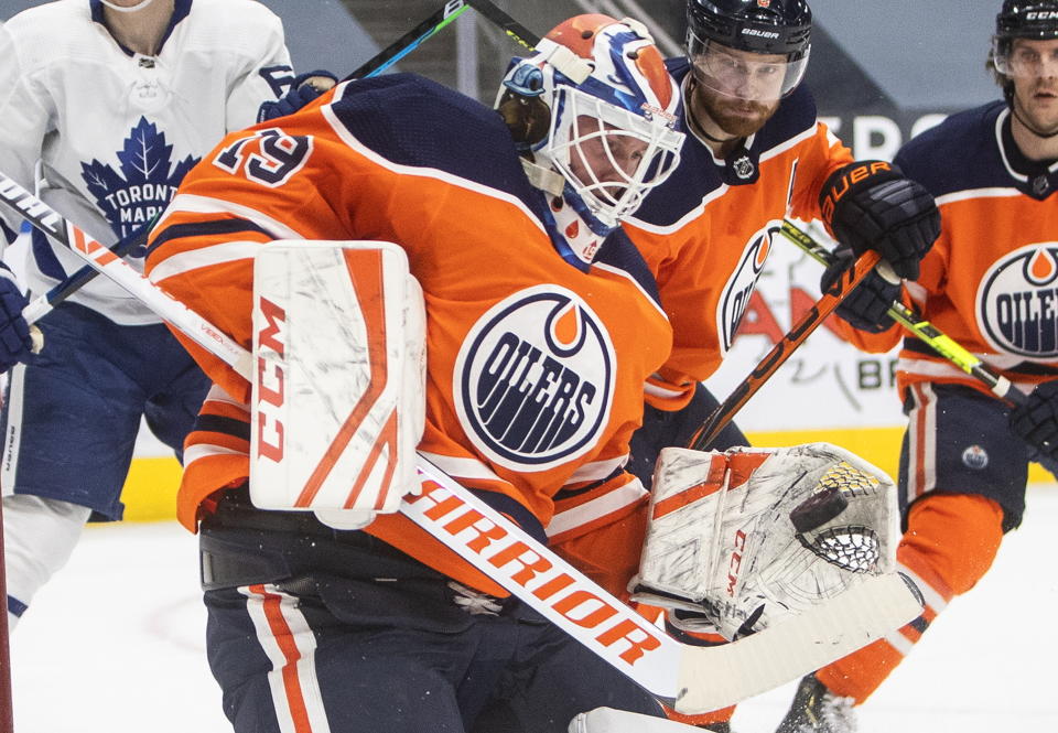 Edmonton Oilers goalie Mikko Koskinen (19) makes a save against the Toronto Maple Leafs during first-period NHL hockey game action in Edmonton, Alberta, Monday, March 1, 2021. (Jason Franson/The Canadian Press via AP)