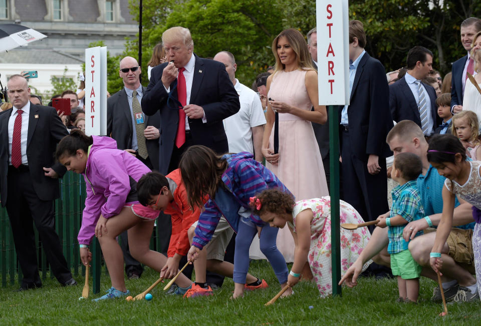 President Donald Trump, accompanied by first lady Melania Trump, blows a whistle to begin an Easter Egg Roll race on the South Lawn of the White House in Washington during the annual White House Eastern Egg Roll. Trump and his wife, Melania, are hosting festivities Monday, April 2, 2018, on the South Lawn for a crowd of nearly 30,000 adults and children. (AP Photo/Susan Walsh)