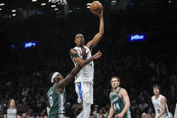 Brooklyn Nets' Nic Claxton shoots next to Detroit Pistons' Jalen Duren, left, and Bojan Bogdanovic, second from right, during the first half of an NBA basketball game Thursday, Jan. 26, 2023 in New York. (AP Photo/Frank Franklin II)